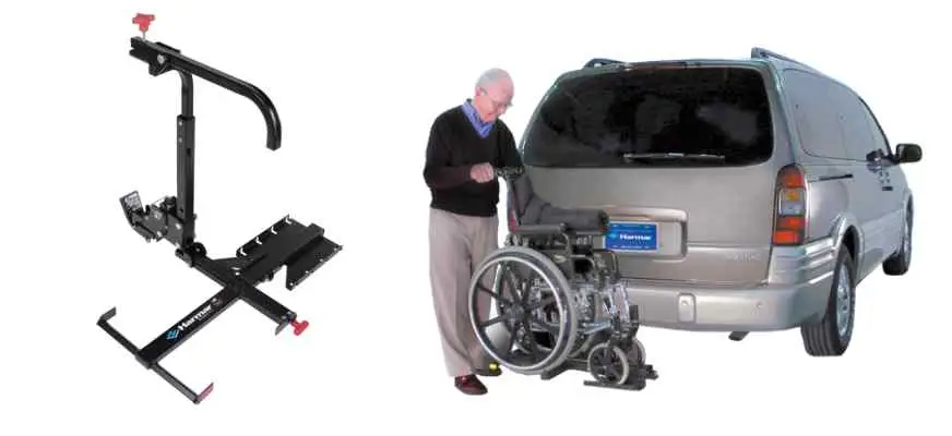 Image of a man placing his manual wheelchair on the Harmar AL003 wheelchair carrier