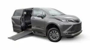 Image of a silver Toyota Sienna Hybrid wheelchair van with an in-floor ramp conversion