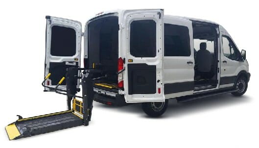 Image showing a Ford Transit ADA wheelchair van from the rear side showing the wheelchair lift