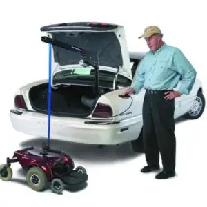Image of a guy using a remote control to lower his mobility scooter out of the trunk of his car using a Harmar AL055 wheelchair lift