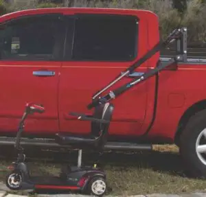Image of a Harmar AL835 wheelchair lift installed in the bed of a red pickup truck