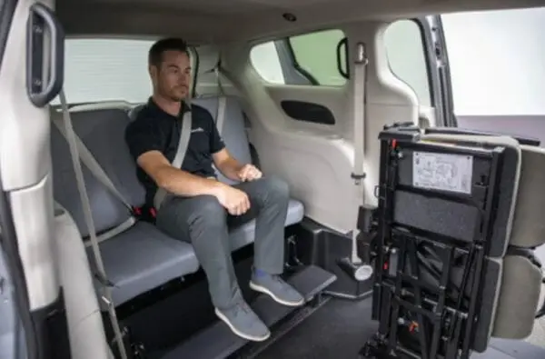 Image of a man sitting in the rear seat on a side entry wheelchair van