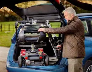 Image of a man unloading his mobility scooter using the smart lifter scooter lift from Mobility Innovations
