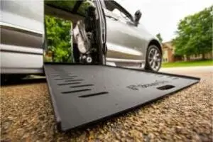 Close up image of an in-floor wheelchair ramp on a silver Chrysler Pacifica wheelchair van from BraunAbility in a driveway