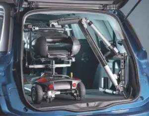 close up image of the Smart Lifter scooter lift and unknown mobility scooter sitting in the rear hatch of a small SUV