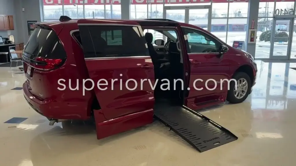 red chrysler pacifica wheelchair van with ramp out and superiorvan.com over the photo