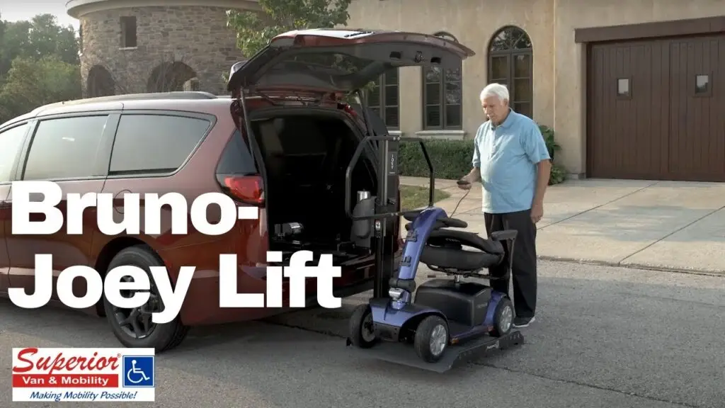 Man loading his mobility scooter into his red minivan using a Bruno Joey lift.