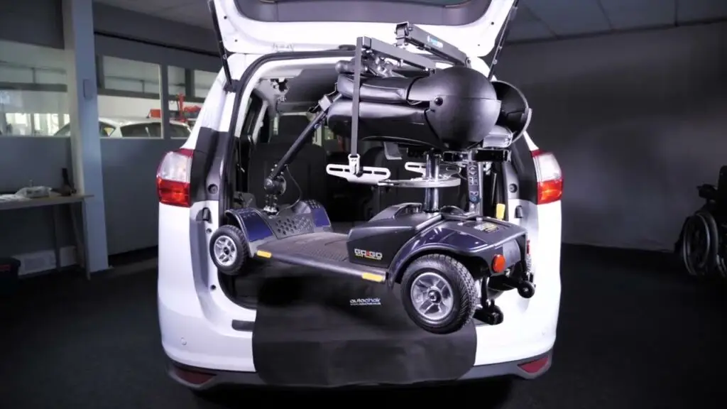 Mobility scooter being loaded into a white minivan using the smart lifter from mobility innovations