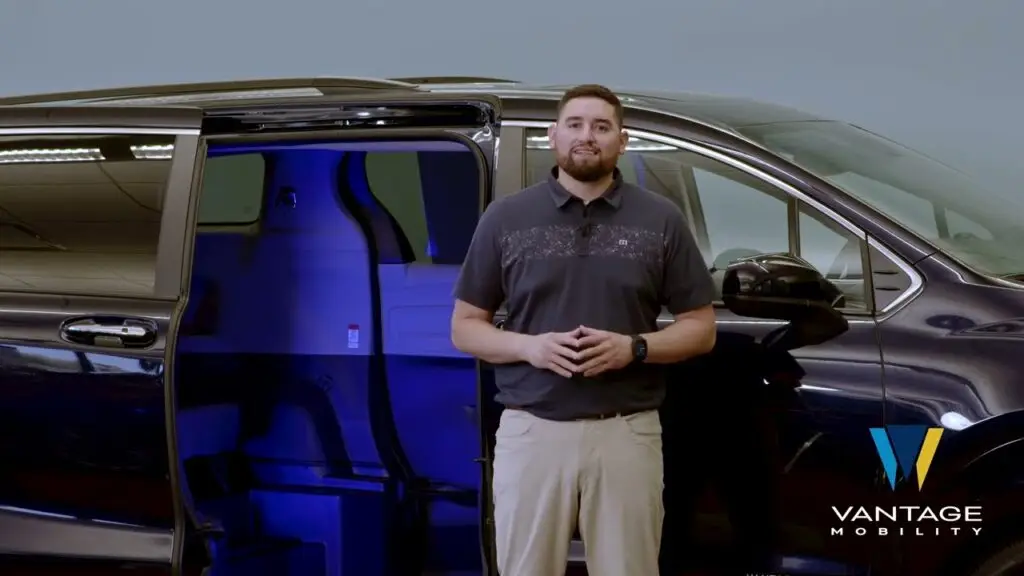 man standing next to a toyota sienna hybrid wheelchair van from vantage mobility