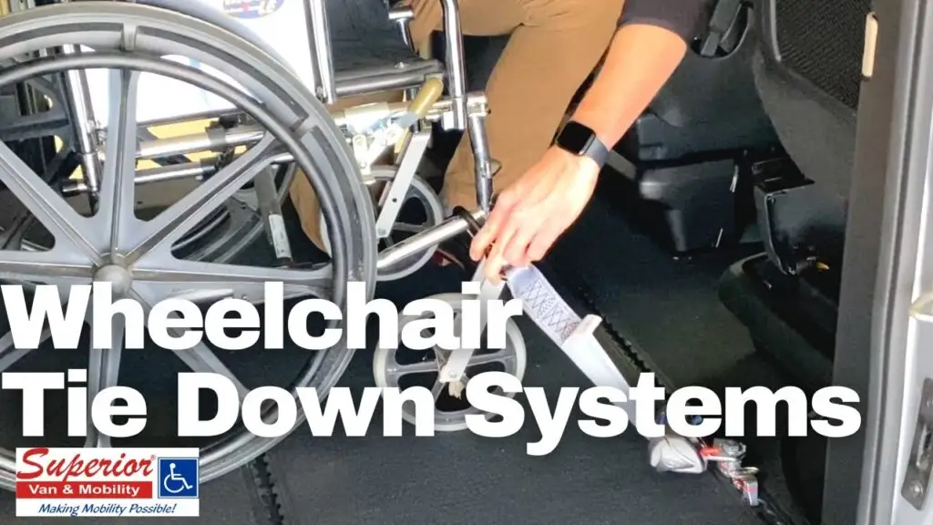 Person showing an up close photo of placing wheelchair restraint on a wheelchair in a minivan