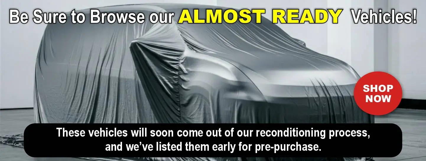 Wheelchair Van under a silver cover with "Be sure to Browse Our Almost Ready Vehicles"
