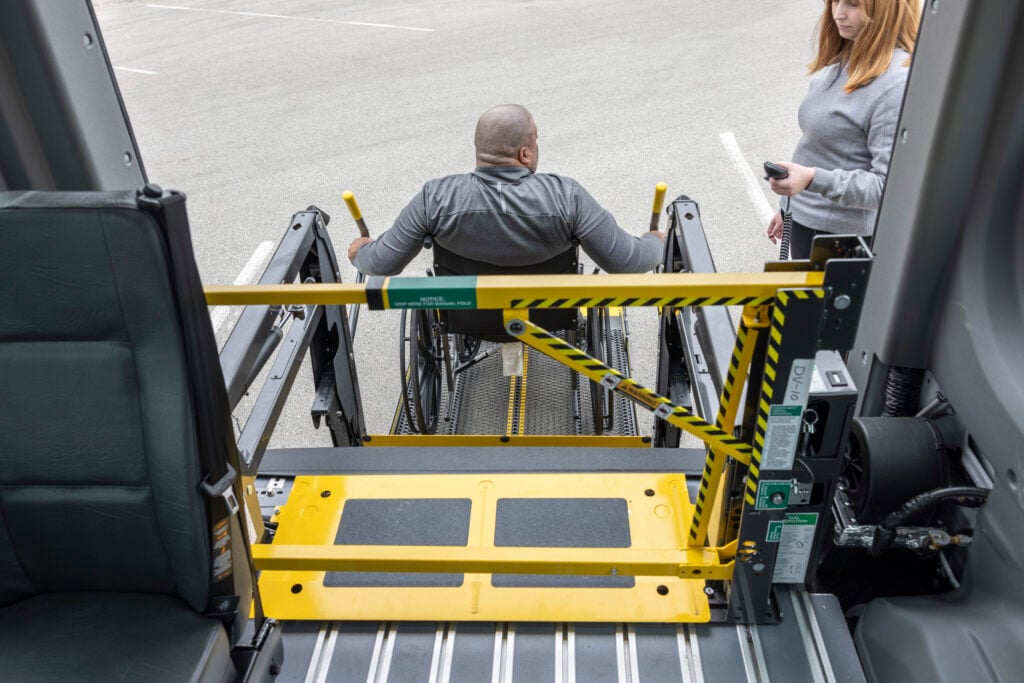 wheelchair user exiting van through rear lift