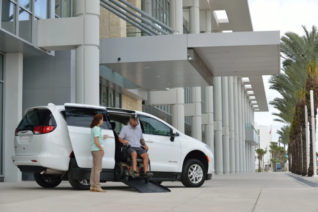 man exiting a side entry foldout van
