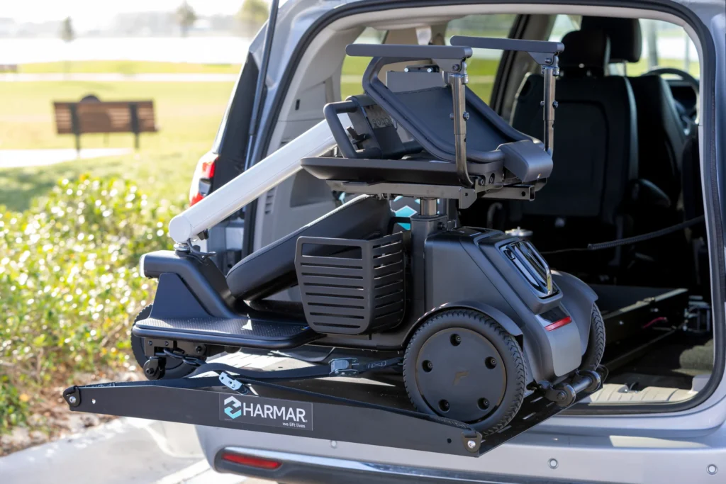 scooter being loaded into back of suv via platform lift