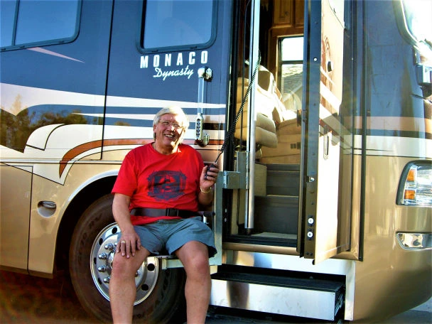man sitting in coach lift rv about to be lifted into rv side