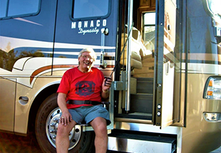 man sitting in coachlift rv lift being lifted into rv