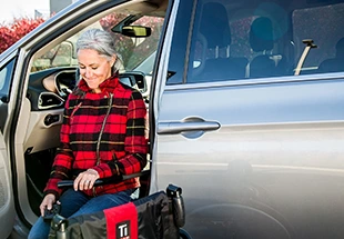 women in transfer seat entering her van