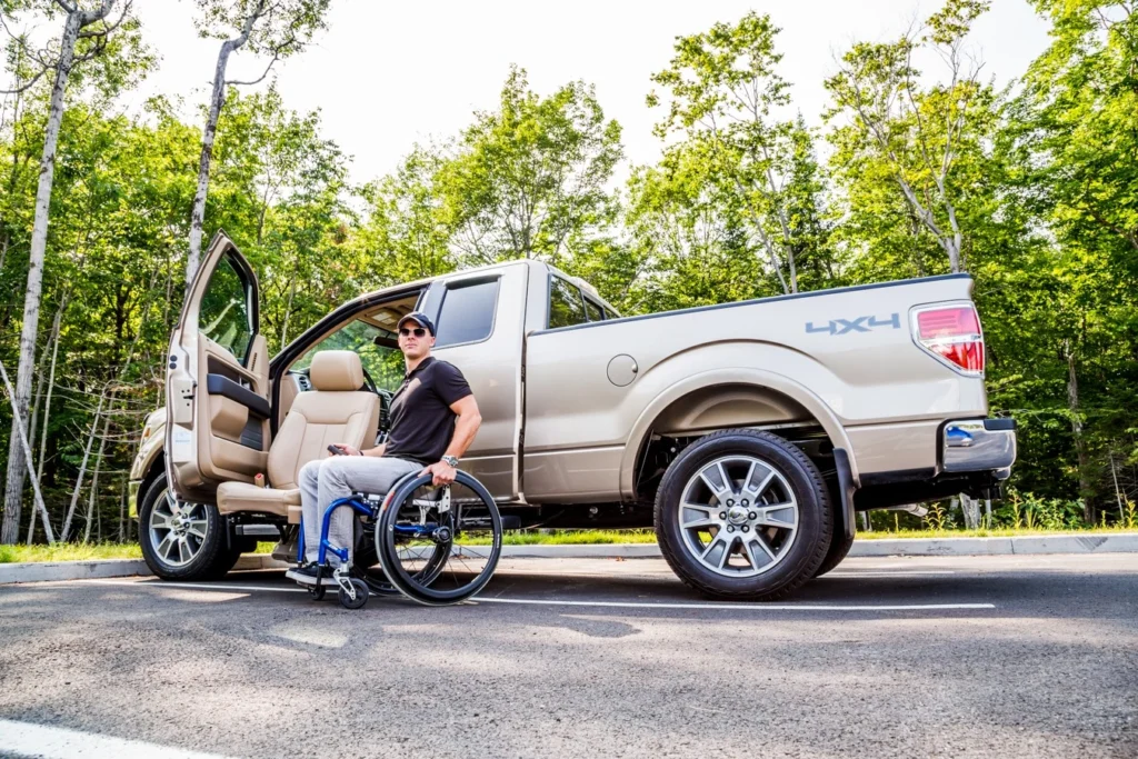Man in adapt link seat outside of his truck