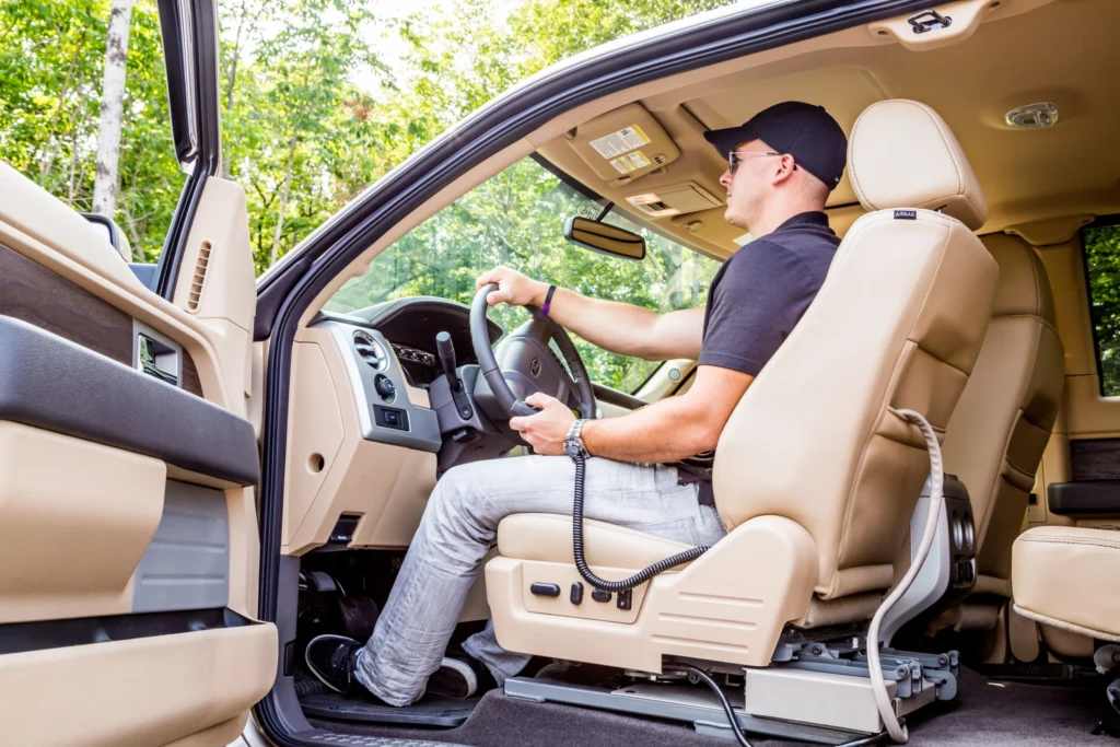 man in driver's seat of truck using link seat