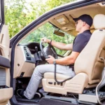 man in driver's seat of truck using link seat